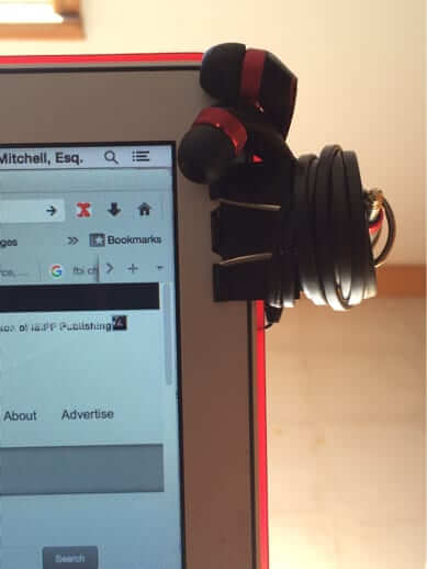 earbuds clip clipped to laptop
